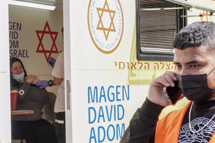 24 February 2021, Israel, Jerusalem: A woman receives her dose of the Pfizer/BioNTech COVID-19 vaccine at a mobile clinic of Magen David Adom parked at the Mahane Yehuda Market. Photo: Nir Alon/ZUMA Wire/dpa