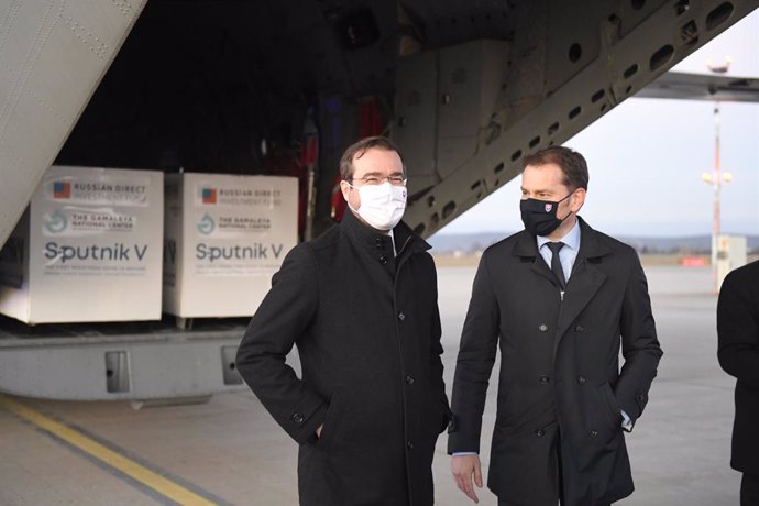 01 March 2021, Slovakia, Kosice: Slovak Prime Minister Igor Matovic (R) and Health Minister Marek Krajci stand in front of an aircraft carrying doses of the Sputnik V's Coronavirus vaccine upon its arrival from Moscow at Kosice International Airport. Ph