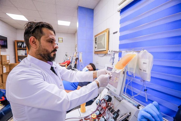 Archivo - Un trabajador médico en Irak con una donación de sangre de un paciente recuperado del coronavirus