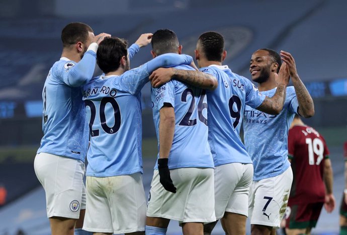 02 March 2021, England, Manchester: Manchester City player celebrate their sides first goal, an own goal by Wolverhampton Wanderers' Leander Dendoncker, during the English Premier League soccer match between Manchester City and Wolverhampton Wanderers a