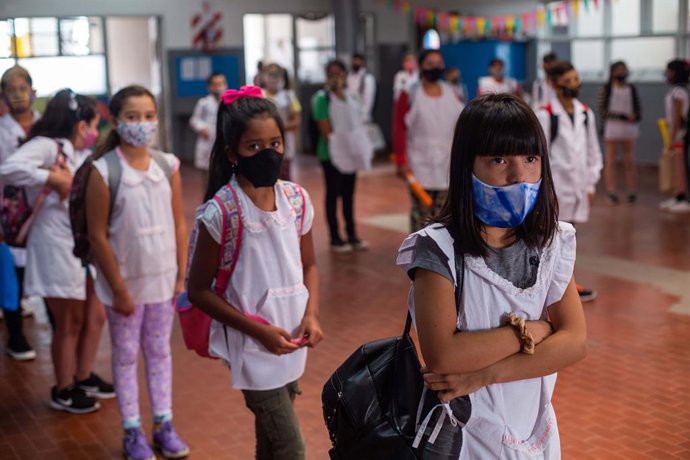 01 March 2021, Argentina, Mar del Plata: Students wearing face masks stand at a distance in the school yard on the first day of partial attendance classes in the region amid the Corona pandemic. Photo: Diego Izquierdo/telam/dpa
