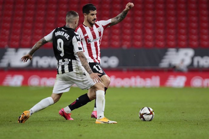 11 February 2021, Spain, Bilbao: Athletic Bilbao's Yuri Berchiche (R)and Levante's Roger Marti battle for the ball during the Spanish Copa del Rey (King's Cup) semi-final leg 1 soccer match between Athletic Bilbao and Levante UD at San Mames Stadium. P