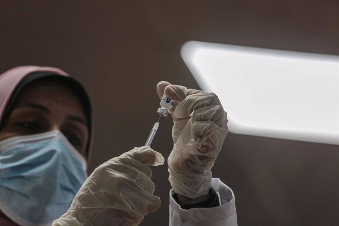 22 February 2021, Palestinian Territories, Gaza City: A Palestinian medic fills up a syringe from a vial of the Sputnik V COVID-19 vaccine, during a vaccination campaign. On Sunday, Mohammad Dahlan, the rival of Palestinian Authority President Mahmoud A