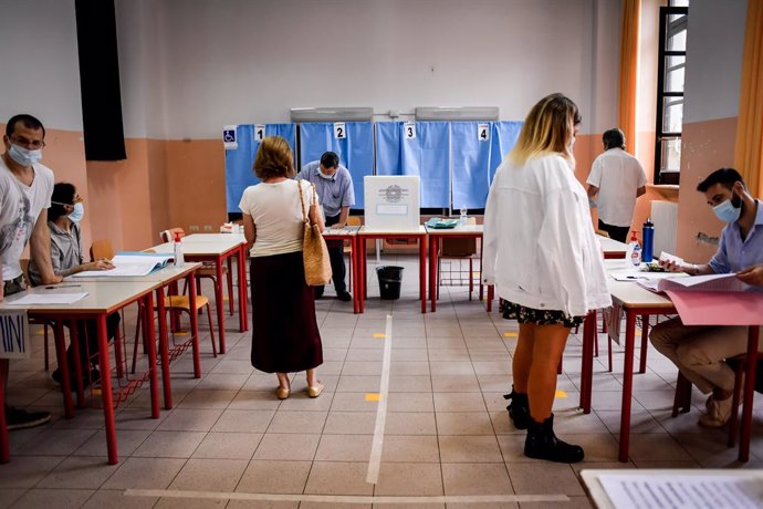 Archivo - 20 September 2020, Italy, Milan: People are seen inside a polling station to cast their vote for a constitutional referendum over the slimming down of parliament and to renew local governors in seven regions, along with mayors in approximately
