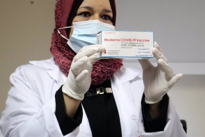 Archivo - Una trabajadora palestina posa con una caja de la vacuna de Moderna.