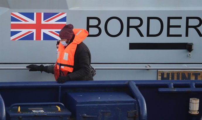 27 February 2021, United Kingdom, Dover: A group of people thought to be migrants are brought in to Dover by Border Force officers following a small boat incident in the English Channel. Photo: Gareth Fuller/PA Wire/dpa