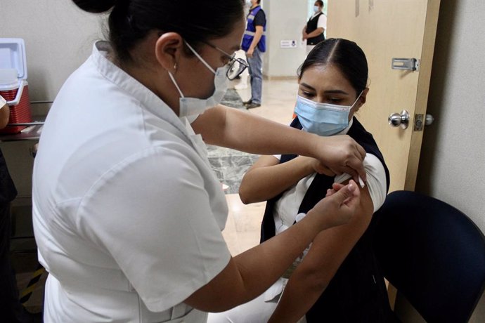18 February 2021, Mexico, Tuxtla Gutierrez: A nurse receives a dose of the coronavirus vaccine in the state of Chiapas. Photo: -/El Universal via ZUMA Wire/dpa