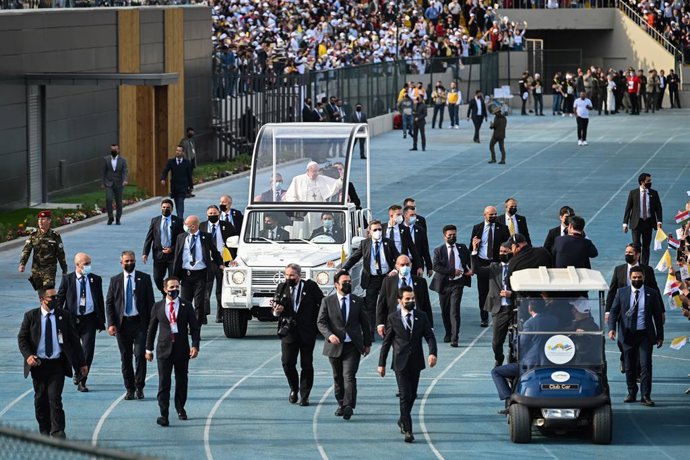 07 March 2021, Iraq, Erbil: Pope Francis (C) waves from his popemobile to the attendees as he arrives into Erbil's Franso Hariri Stadium to lead a mass as part of his visit to the autonomous Kurdistan Region in northern Iraq. Pope Francis arrived in Ira