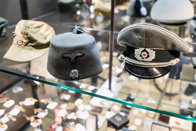 Archivo - 20 November 2019, Bavaria, Grasbrunn: A tropical army field cap, a fez for the field uniform of the Muslim legionnaires of the Waffen-SS and an umbrella cap for officers of the infantry are seen on display at the Hermann Historica auction hous