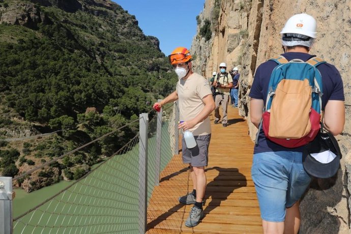 Archivo - Foto de archivo de un trabajador del Caminito del Rey desinfecta la barandilla durante la jornada previa a su reapertura en la fase 3 del plan de desescalada por el COVID-19
