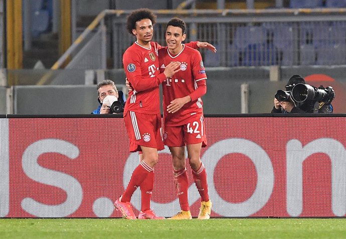 23 February 2021, Italy, Rome: Munich's Jamal Musiala (R) celebrates with team mate Leroy Sane after scoring their side's second goal during the UEFAChampions League round of 16 first leg soccer match between SS Lazio and FC Bayern Munich at the Olympi