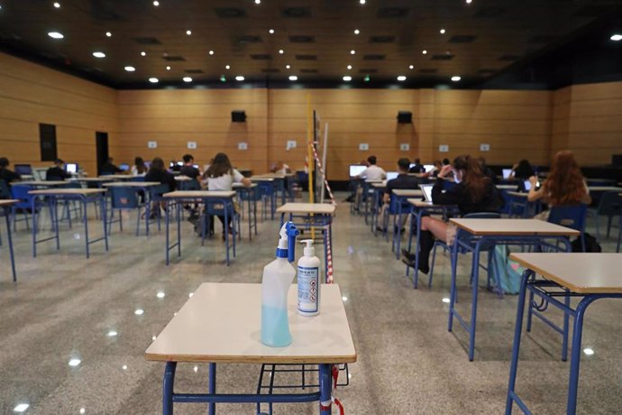 Archivo - Productos desinfectantes colocados en los pupitres desde donde los alumnos atienden a las clases virtuales impartidas en el Colegio Ábaco, en Madrid (España), a 17 de septiembre de 2020. 