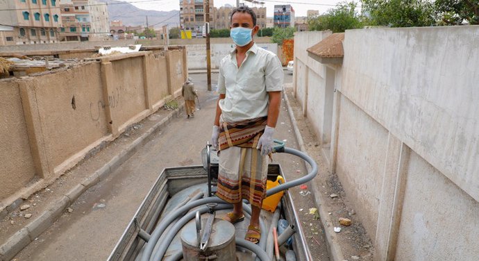 Archivo - Un hombre trabaja en un camión que facilita agua limpia en Saná.