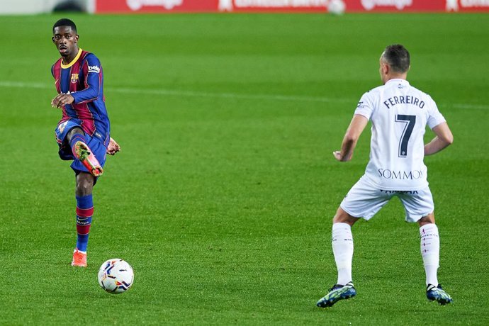 15 March 2021, Spain, Barcelona: Barcelona's Ousmane Dembele and Huesca's David Ferreiro in action during the Spanish Primera Division soccer match between FC Barcelona and SD Huesca at Camp Nou stadium. Photo: Gerard Franco/DAX via ZUMA Wire/dpa