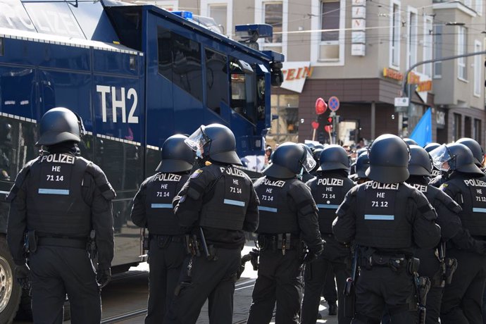 20 March 2021, Hessen, Kassel: Police forces stand guard during an unregistered demonstration against the government's Corona policy. Photo: Swen Pfrtner/dpa