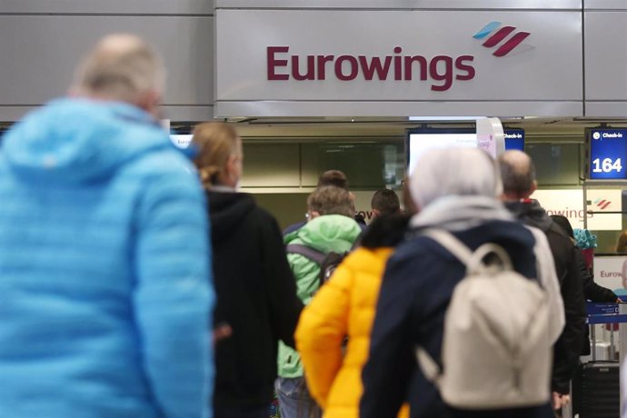 Pasajeros alemanes en el Aeropuerto de Duesseldorf reservando vuelo hacia Mallorca