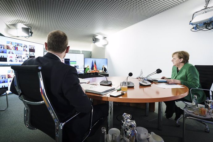 HANDOUT - 22 March 2021, Berlin: German Chancellor Angela Merkel (R) and Governing Mayor of Berlin Michael Mueller participate in a video conference with the German Minister Presidents to discuss the latest updates regarding the coronavirus pandemic. Ph