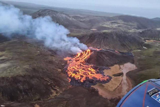 HANDOUT - 20 March 2021, Iceland, Reykjanes Peninsula: An aerial from a coast guard helicopter shows the eruption at Fagradalsfjall volcano near the Icelandic capital Reykjavik. The Department of Civil Protection and Emergency Management urged residents