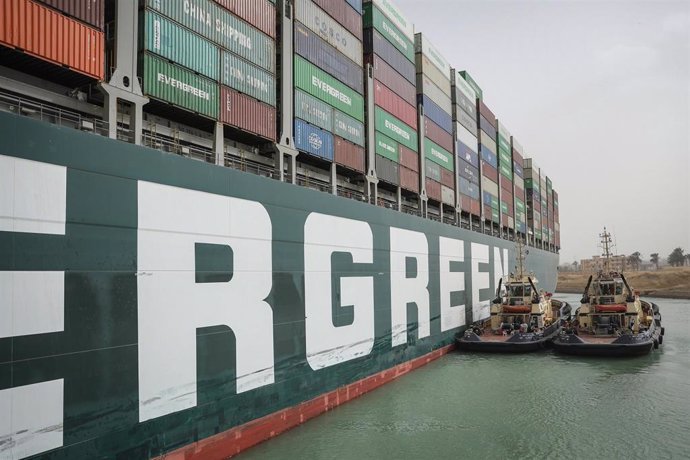 HANDOUT - 25 March 2021, Egypt, Suez: Two tugboat take part in the refloating operation carried out to free the "Ever Given", a container ship operated by the Evergreen Marine Corporation, which is currently stuck in the Suez Canal. The state-run Suez C
