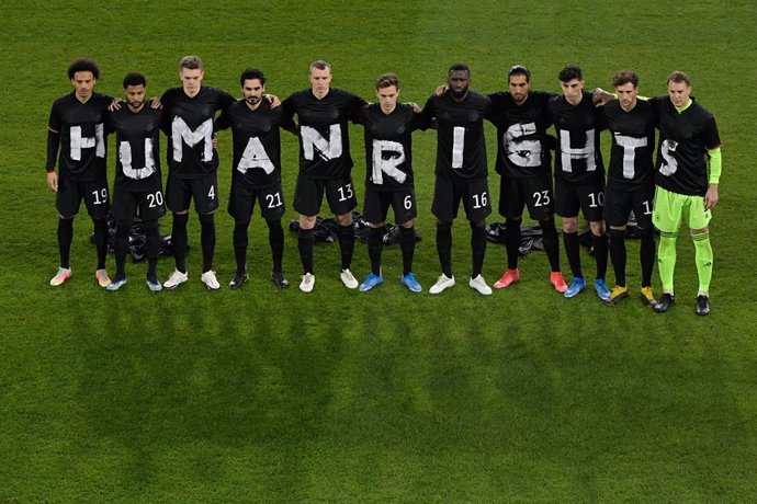 25 March 2021, North Rhine-Westphalia, Duisburg: players of the German national team stand together and form the lettering "Human Rights" prior to the start of the 2022 FIFA World Cup European Qualifiers Group J soccer match between Germany and Iceland 