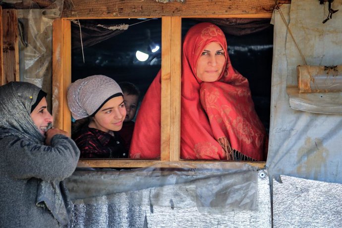 13 March 2021, Lebanon, Aarsal: A group of Syrian refugee women stand near a tent at the Barra refugee camp in the Lebanese town of Aarsal, located north-east of capital Beirut. UNICEF said that after 10 years since the start of the Syrian conflict, war