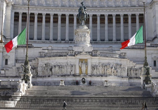 18 March 2021, Italy, Rome: Flags are at half mast at Rome's Altar of the Fatherland, as Italy marks the first national day of remembrance for victims of the Coronavirus pandemic, which hit the country harder than many others in Europe in 2020. Photo: C