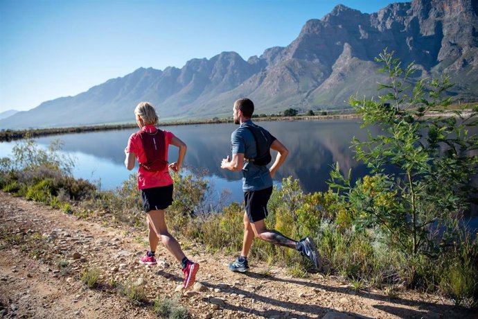 Pareja corriendo por el campo