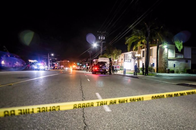 31 March 2021, US, Orange: Police tape cordons off the crime scene where four people, including a child, were killed after a shooting occurred in a business building in Orange On Wednesday evening. This is the third mass shooting incident in the United 