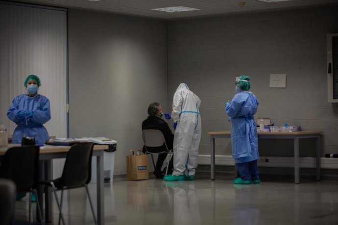 Archivo - Un hombre recibe una prueba PCR en un dispositivo de cribados masivos en el barrio del Raval, en Barcelona (España), a 7 de diciembre de 2020. 