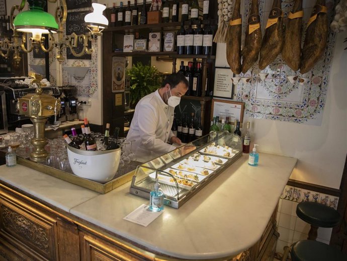 A waiter serves 'tapas' at 'Taberna del Alabardero' during the Coronavirus pandemic on March 20, 2021 in Madrid, Spain.