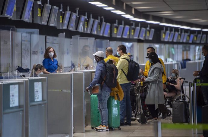 Varios pasajeros se disponen a facturar para coger uno de los últimos vuelos destino Casablanca (Marruecos), en la Terminal T1 del Aeropuerto Madrid - Barajas Adolfo Suárez, en Madrid (España), a 30 de marzo de 2021. La Dirección General de Aviación Civ