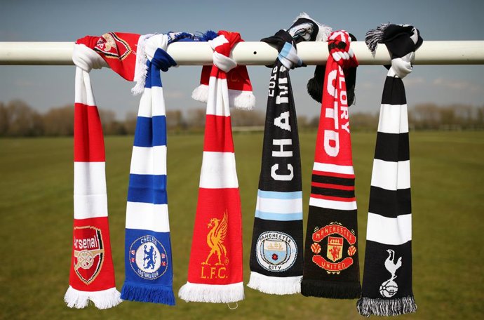 19 April 2021, United Kingdom, London: A selection of scarves bearing the crests of English soccer Premier League teams (L-R) Arsenal, Chelsea, Liverpool, Manchester City, Manchester United and Tottenham Hotspur are seen at Hackney Marshes after the clu