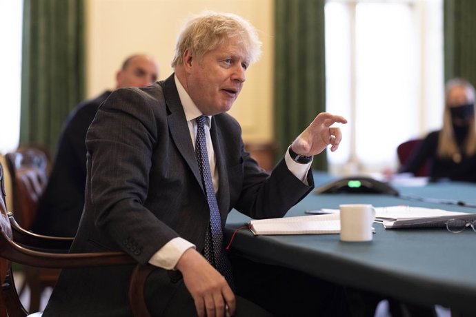 HANDOUT - 20 April 2021, United Kingdom, London: Uk Prime Minister Boris Johnson holds a virtual roundtable with Oliver Dowden, Secretary for Digital, Culture Media and Sports and football fans who are concerned over the Premier League clubs that have s