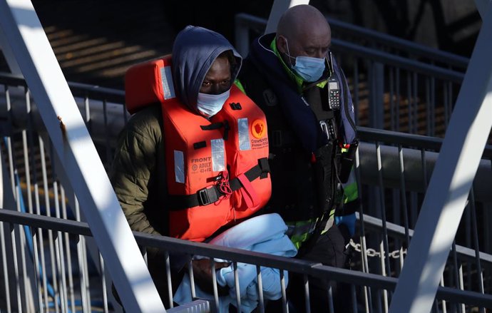 13 April 2021, United Kingdom, Dover: A man thought to be migrant is brought in to Dover, by Border Force officers following a small boat incident in the Channel. Photo: Gareth Fuller/PA Wire/dpa