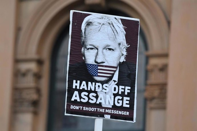 A placard is seen at a Free Julian Assange protest rally outside Sydney Town Hall in Sydney, Friday, April 23, 2021. Since his arrest on 11 April 2019, Assange has been incarcerated in HM Prison Belmarsh in London. (AAP Image/Mick Tsikas) NO ARCHIVING