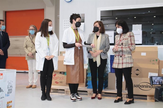 La consejera de Salud de La Rioja, Sara Alba (2i), y la ministra de Sanidad, Carolina Darias (d), conversan durante la recepción de un nuevo envío de vacunas de Pfizer/BioNTech contra el Covid-19