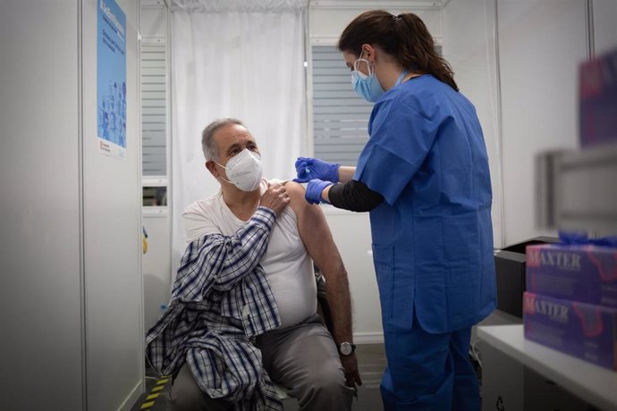 Una sanitaria vacuna a un hombre en el circuito de vacunación de Fira de Barcelona