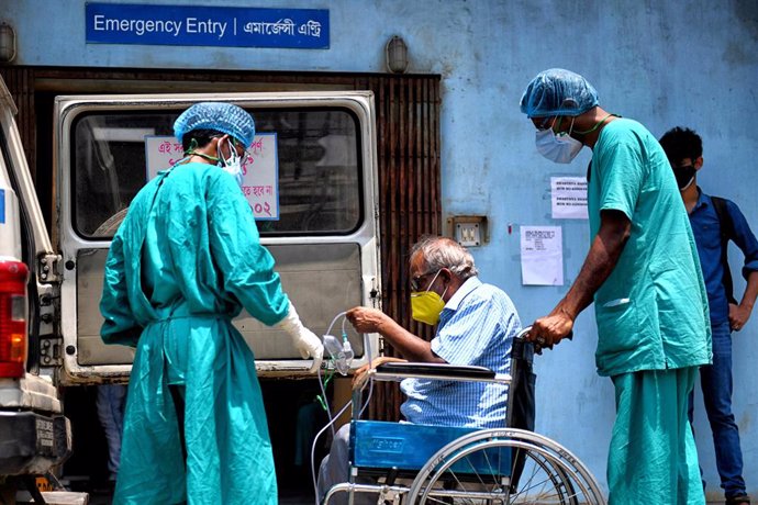 27 April 2021, India, Kolkata: A Coronavirus (Covid-19) patient sits on a wheel chair going for a medical check up at a government hospital. India hit record numbers of Covid-19 infections worldwide for the sixth day running on Tuesday, as health system
