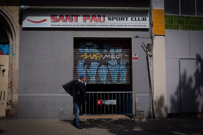 Un home sense llar surt del gimns social Sant Pau, a 28 d'abril de 2021, a Barcelona, Catalunya, (Espanya). 