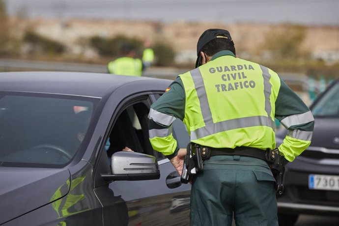 Archivo - Un Guardia Civil de Tráfico pide la documentación durante un control en la carretera R5 km 20, en Madrid (España), a 26 de marzo de 2021. 