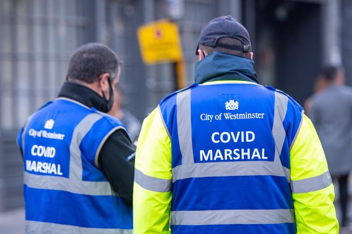 24 April 2021, United Kingdom, London: Covid Marshals on duty in Soho square following the further easing of lockdown restrictions in England. Photo: Dominic Lipinski/PA Wire/dpa