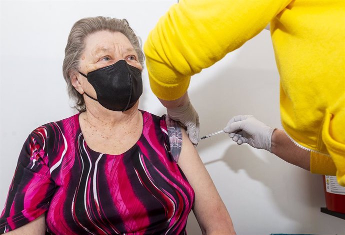 22 April 2021, Czech Republic, Most: An elderly woman receives a dose of a COVID-19 vaccine in a vaccination center. Photo: Hájek Ondej/CTK/dpa