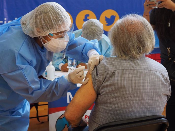 17 April 2021, Peru, Lima: An elderly woman receives a dose of a COVID-19 vaccine in a sports center. The Peruvian Government enabled the sports venues of the Lima 2019 Pan American Games as vaccination centers. Photo: Carlos Garcia Granthon/ZUMA Wire/d