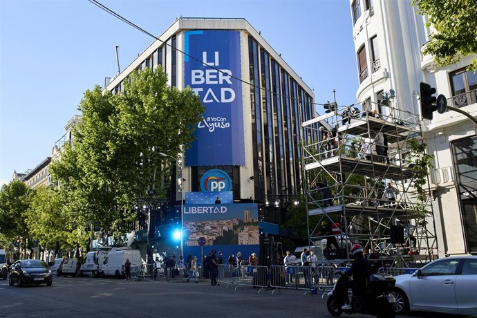 Sede del PP con lonas colgadas en su fachada minutos antes de que comience el recuento de las votaciones de la jornada electoral
