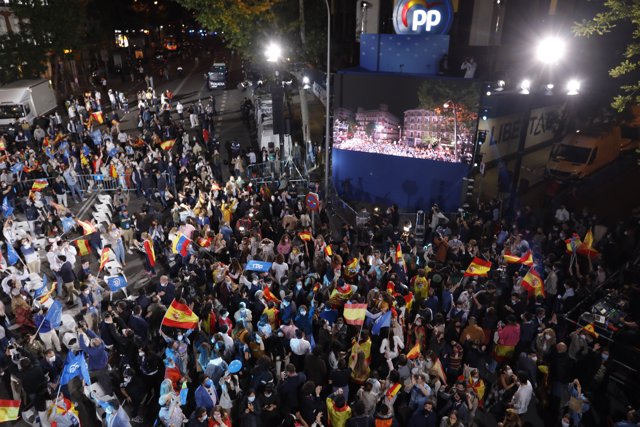 Seguidores del Partido Popular celebran con banderas de España los primeros datos