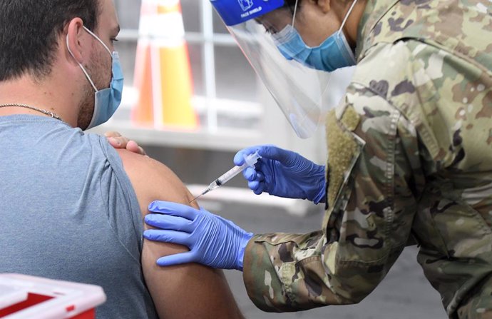25 April 2021, US, Orlando: A man gets vaccinated against Coronavirus at the FEMA-supported COVID-19 vaccination site at Valencia State College, on the first day the site resumed offering the Johnson & Johnson vaccine following the lifting of the pause 