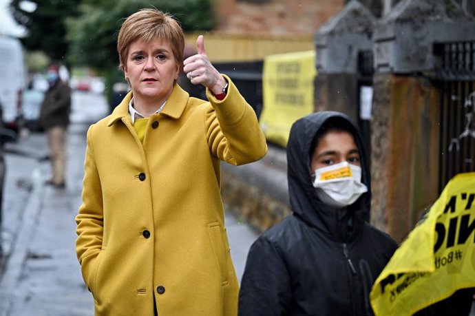 06 May 2021, United Kingdom, Glasgow: First Minister and leader of the Scottish National Party (SNP) Nicola Sturgeon (L) arrives to cast her vote at a polling station during the Scottish Parliamentary election. Photo: Jeff J Mitchell/PA Wire/dpa