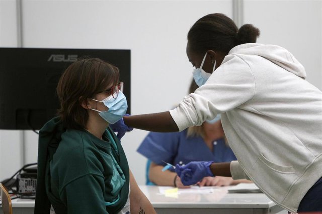 Archivo - Un empleada sanitaria suministra la vacuna contra la Covid-19 en el dispositivo de vacunación puesto en marcha en el polideportivo Germans Escales, en Palma de Mallorca.