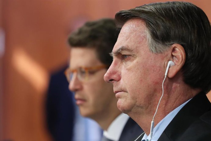 HANDOUT - 22 April 2021, Brazil, Brasilia: Brazilian President Jair Bolsonaro (R) attends the virtual Leaders Summit on Climate, called on by USPresident Joe Biden. Photo: Marcos Correa/Palácio do Planalto/dpa - ATTENTION: editorial use only and only i