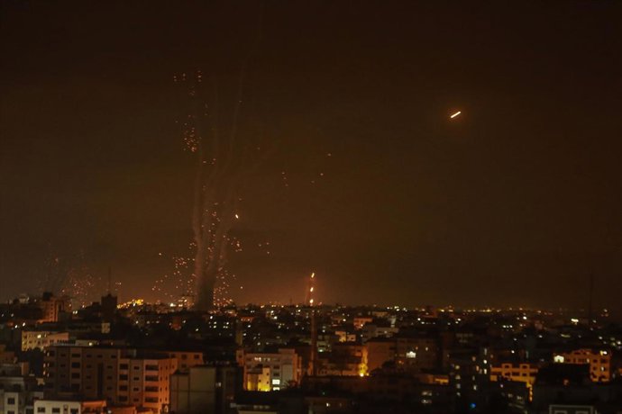 10 May 2021, Palestinian Territories, Gaza City: Israel's Iron Dome aerial defence system intercepts rockets fired by the Palestinian Islamist movement Hamas from Gaza towards Israel. The Islamist Hamas movement that rules Gaza said Monday it launched s